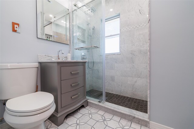 bathroom featuring tile patterned flooring, a shower stall, toilet, and vanity