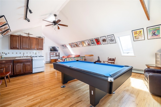 rec room featuring ceiling fan, light wood-style flooring, a sink, baseboard heating, and lofted ceiling with skylight