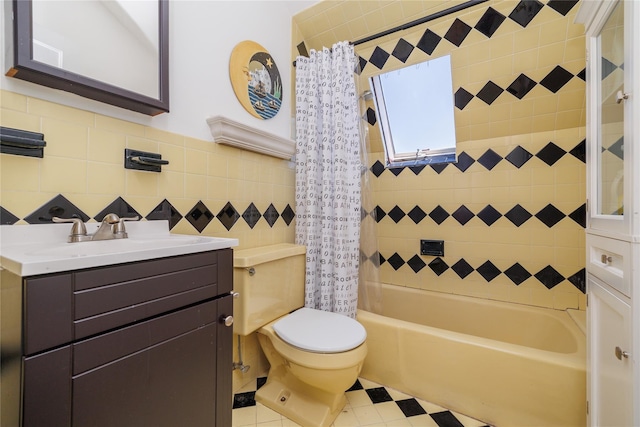 bathroom with shower / tub combo, tile walls, toilet, and vanity