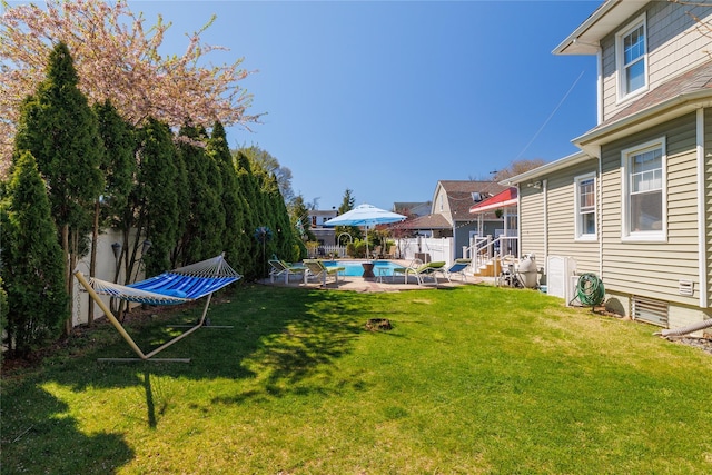 view of yard featuring a patio area, fence, and a fenced in pool