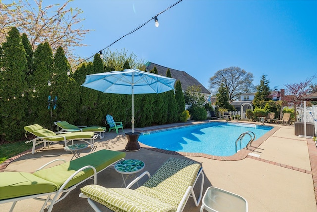 view of swimming pool with a patio area, fence, and a fenced in pool