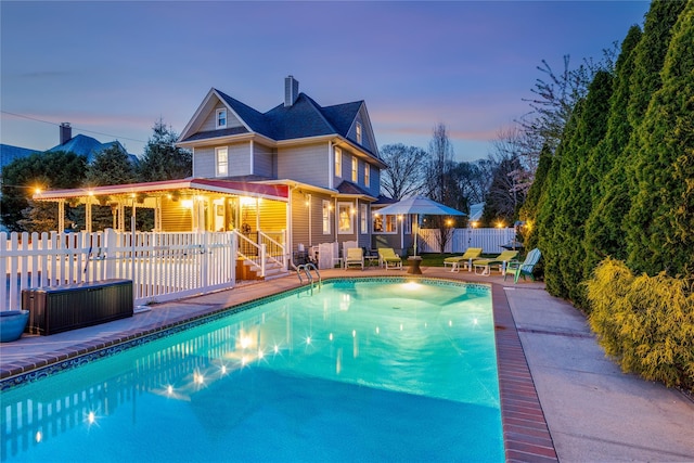 view of swimming pool featuring a fenced in pool, a patio area, and fence