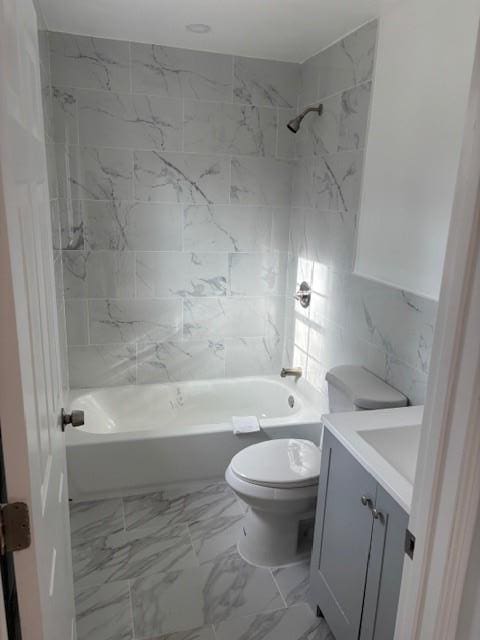 full bathroom featuring toilet, marble finish floor, shower / bath combination, and vanity