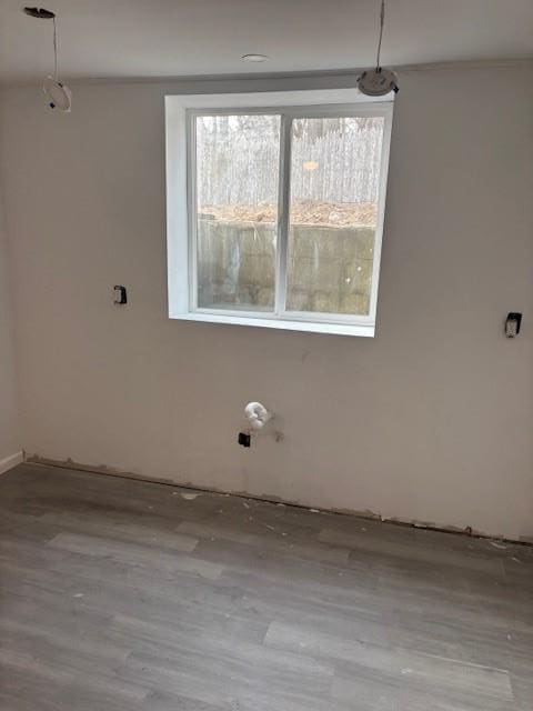 clothes washing area featuring wood finished floors