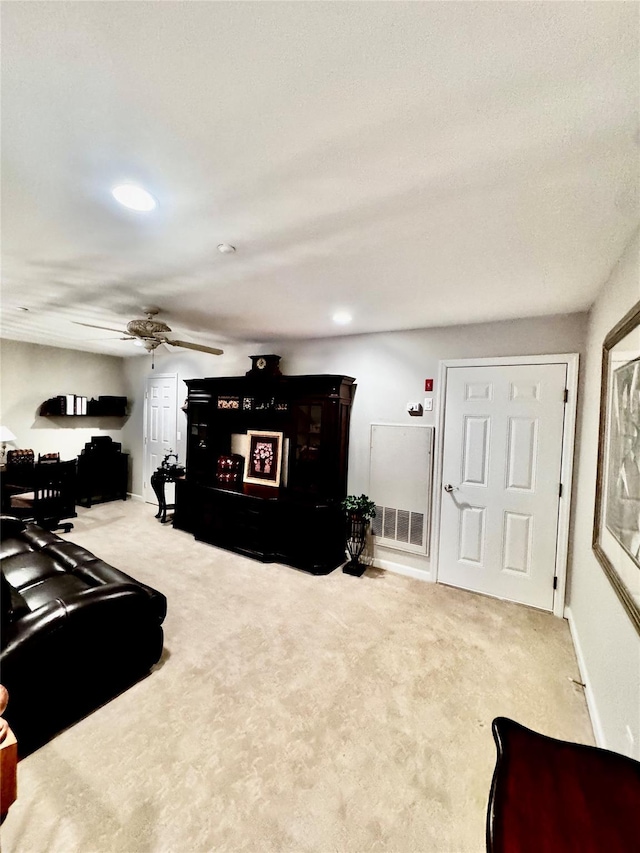 living room with carpet, visible vents, ceiling fan, and baseboards
