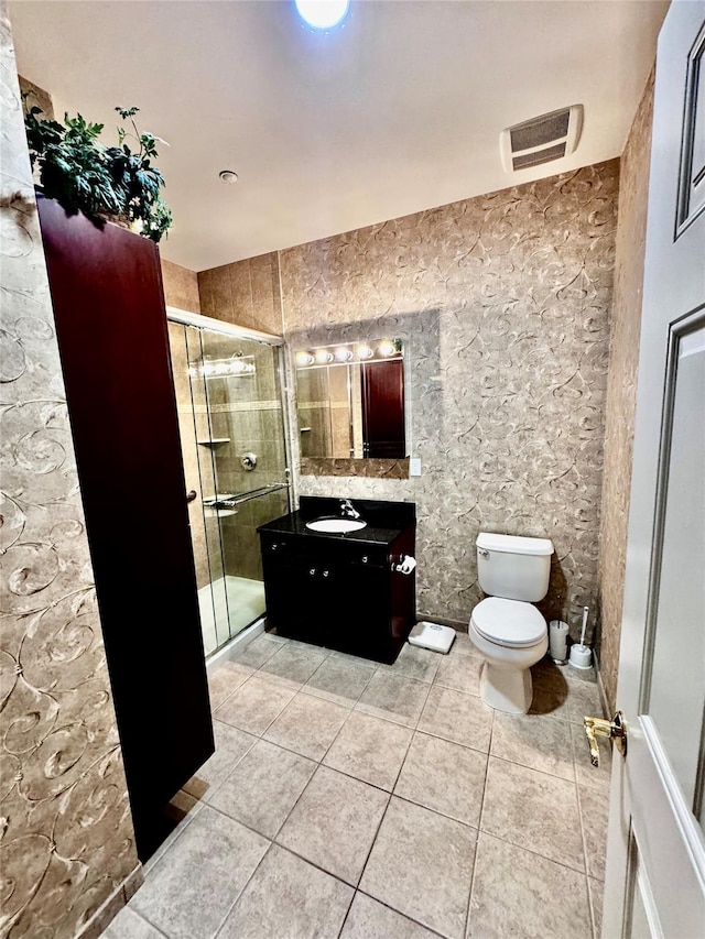 bathroom with visible vents, toilet, tile patterned flooring, vanity, and a shower stall