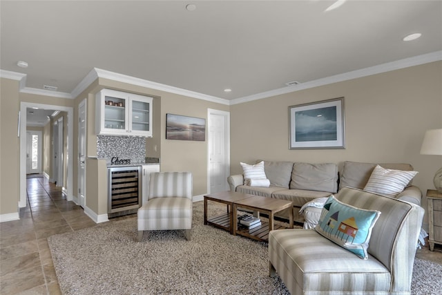 living area featuring wine cooler, crown molding, a dry bar, light tile patterned floors, and baseboards