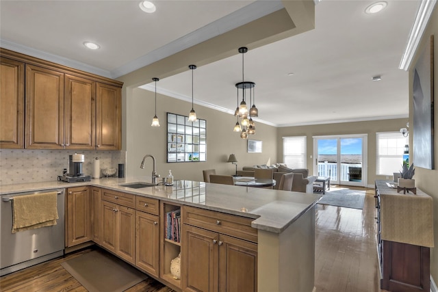 kitchen featuring dishwasher, open floor plan, dark wood-style flooring, a peninsula, and a sink