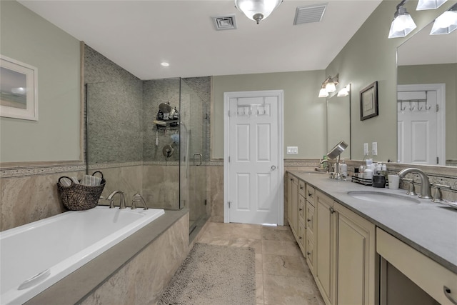 bathroom with a garden tub, visible vents, a sink, and a stall shower