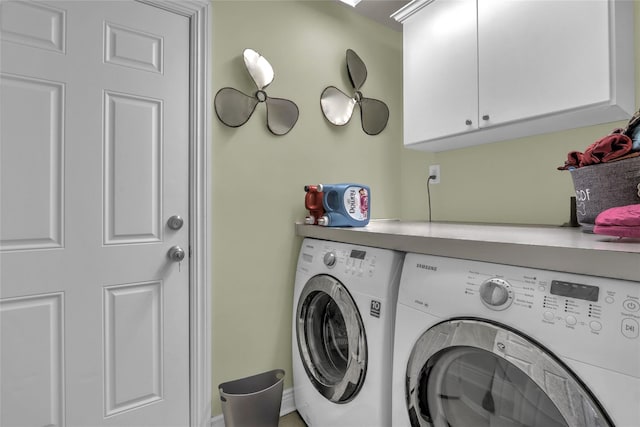 laundry area with washing machine and dryer and cabinet space