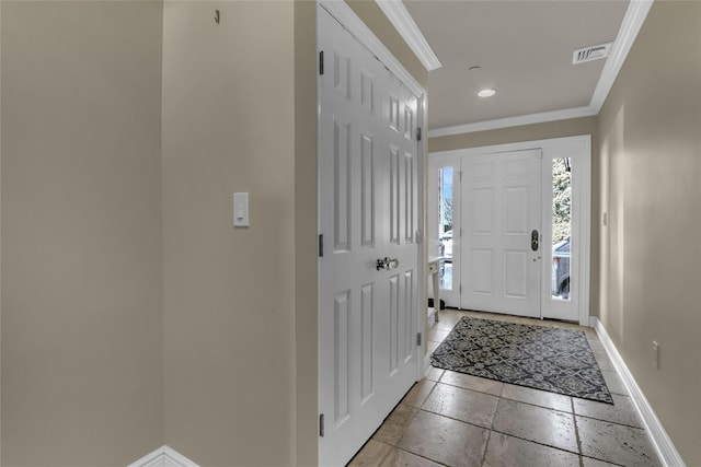 entrance foyer with recessed lighting, stone tile flooring, visible vents, ornamental molding, and baseboards