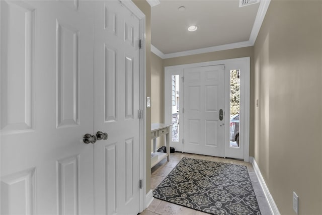 foyer featuring light tile patterned flooring, crown molding, visible vents, and baseboards