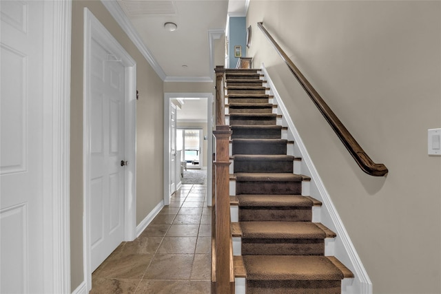 stairs with visible vents, crown molding, and baseboards