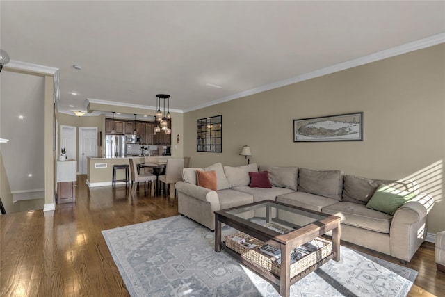 living room featuring ornamental molding, dark wood finished floors, and baseboards