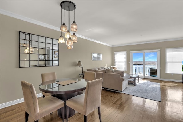 dining area featuring ornamental molding, plenty of natural light, and hardwood / wood-style floors