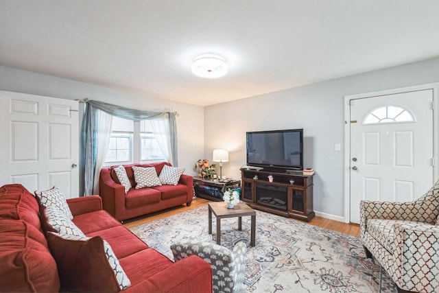 living room featuring light wood-style flooring and baseboards