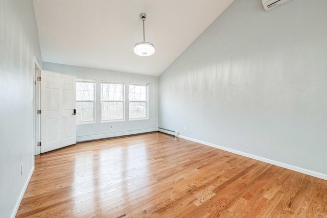 unfurnished room with baseboards, vaulted ceiling, an AC wall unit, baseboard heating, and light wood-type flooring