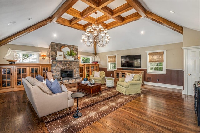 living room with a wainscoted wall, plenty of natural light, a fireplace, and dark wood-style flooring