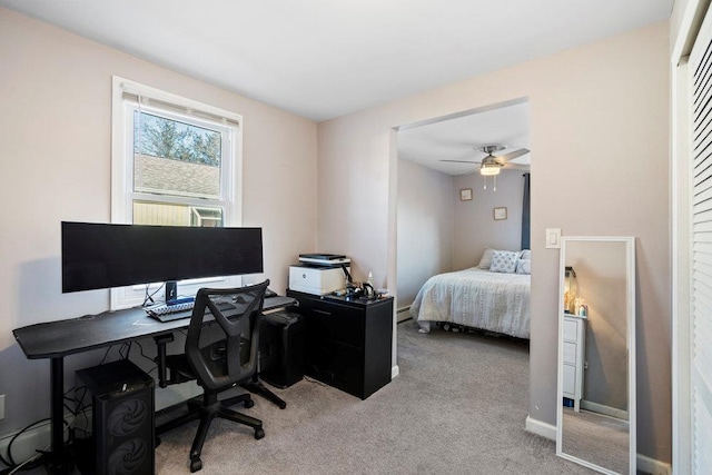 bedroom with a baseboard heating unit, baseboards, and light colored carpet