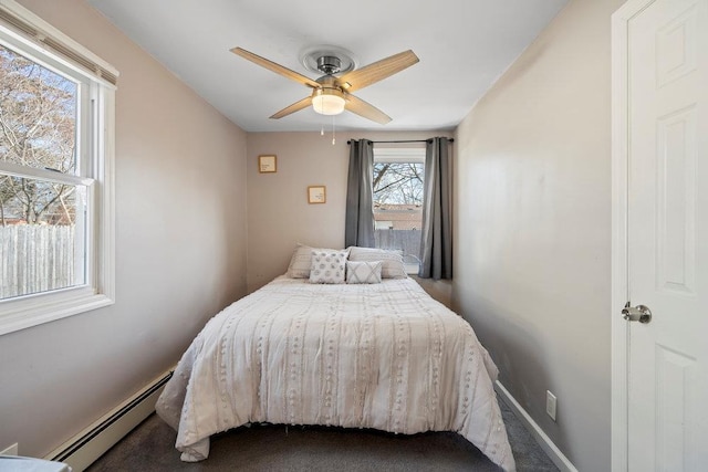 bedroom featuring a baseboard radiator, baseboards, ceiling fan, and carpet flooring