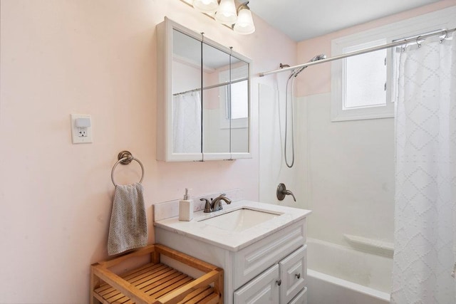 bathroom featuring shower / bath combination with curtain, a wealth of natural light, and vanity