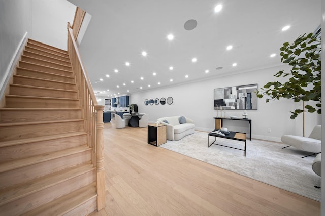 living room with recessed lighting, stairway, baseboards, and wood finished floors