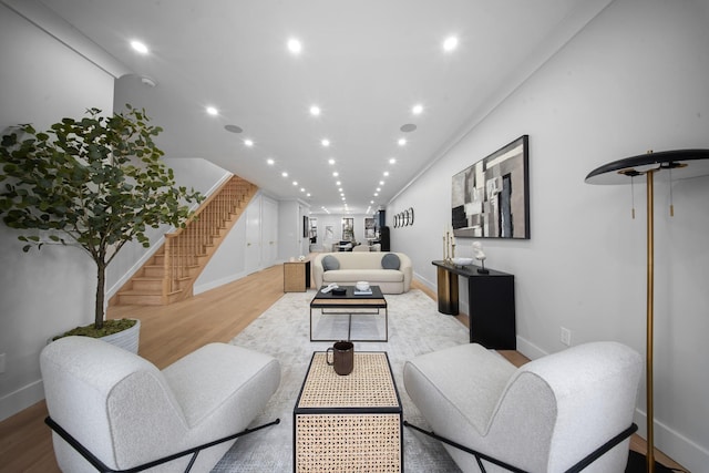 living room with light wood finished floors, recessed lighting, stairs, and baseboards