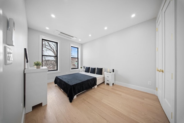 bedroom featuring recessed lighting, light wood-style floors, and baseboards