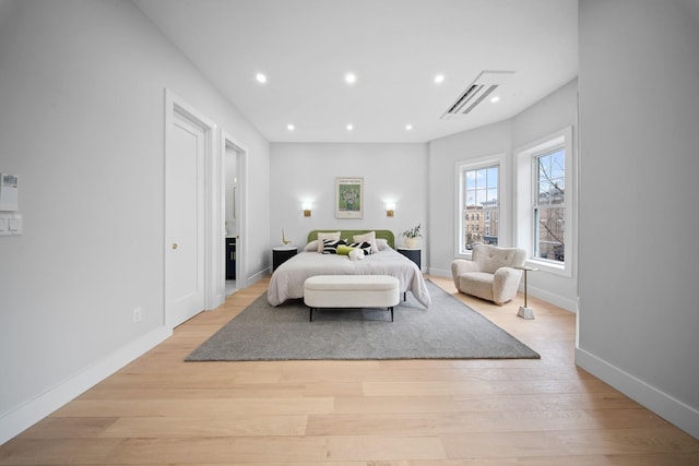 bedroom with recessed lighting, baseboards, and light wood-style floors