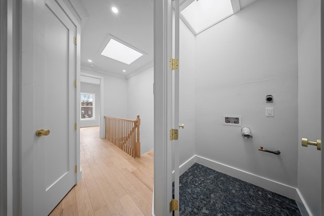 laundry area with wood finished floors, washer hookup, laundry area, a skylight, and hookup for a gas dryer