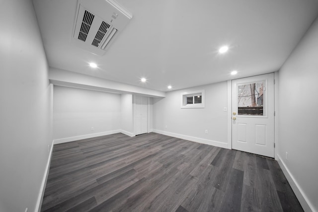 basement featuring recessed lighting, visible vents, baseboards, and dark wood finished floors