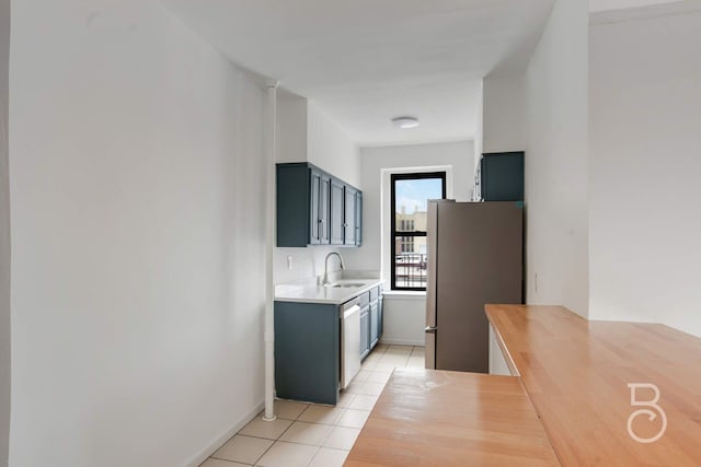 37-16 83rd St Unit 4E, Jackson Heights, NY 11372 - kitchen featuring appliances with stainless steel finishes, light tile patterned floors, and butcher block counters