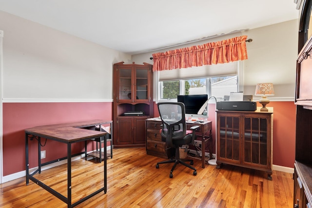 office area with hardwood / wood-style flooring and baseboards