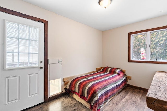 bedroom featuring wood finished floors and baseboards