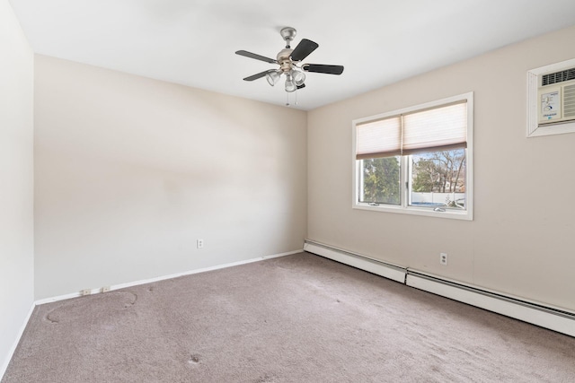 carpeted spare room featuring a baseboard heating unit, baseboards, and a ceiling fan