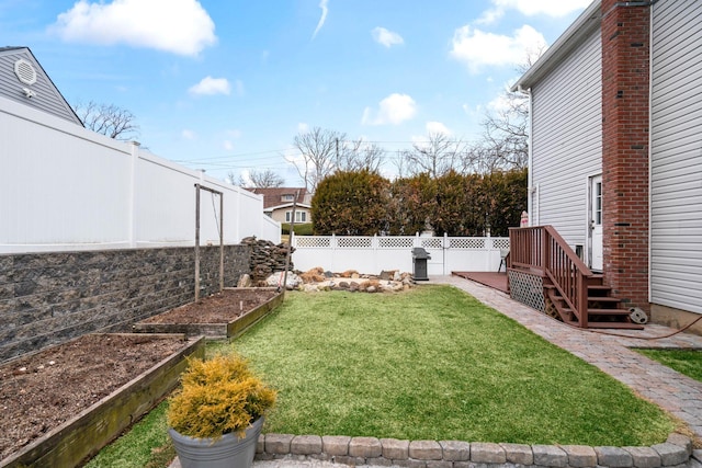 view of yard with a garden and a fenced backyard