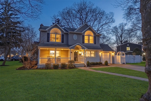 view of front of house featuring a chimney, a porch, concrete driveway, fence, and a front lawn