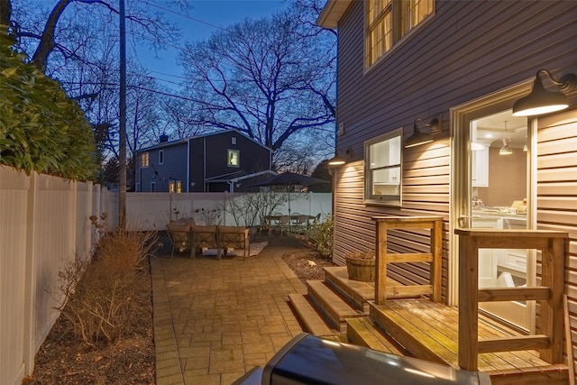 deck with a patio area and a fenced backyard