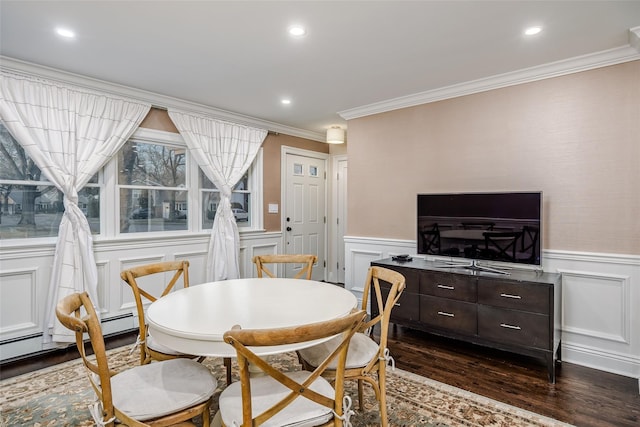 dining room featuring dark wood-style floors, recessed lighting, a wainscoted wall, and ornamental molding