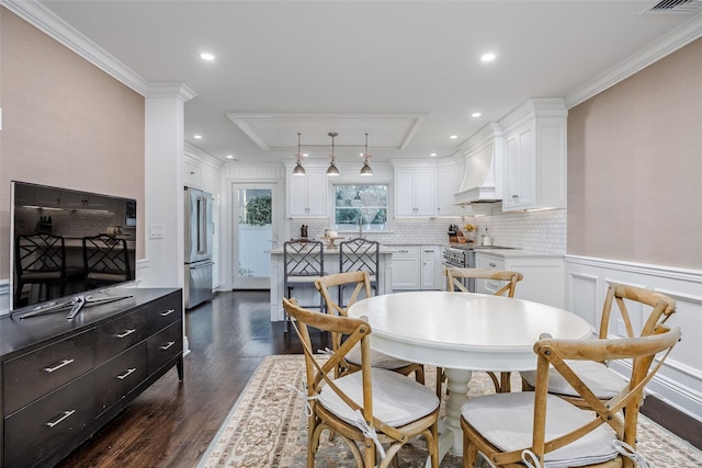 dining area featuring recessed lighting, ornamental molding, dark wood finished floors, and wainscoting