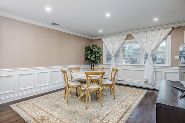 dining room featuring dark wood-style floors, ornamental molding, a baseboard radiator, and visible vents