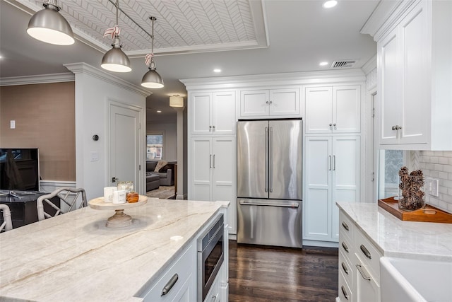 kitchen with dark wood-style flooring, crown molding, stainless steel appliances, white cabinets, and light stone countertops