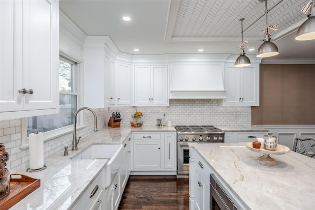 kitchen featuring dark wood-style floors, decorative light fixtures, custom exhaust hood, appliances with stainless steel finishes, and white cabinets