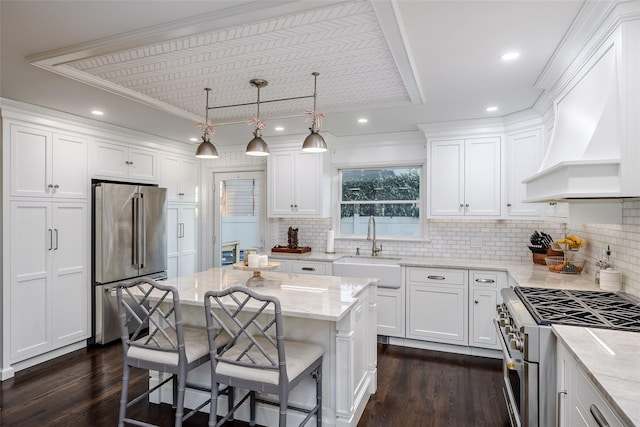 kitchen with premium appliances, a sink, white cabinetry, custom exhaust hood, and dark wood-style floors