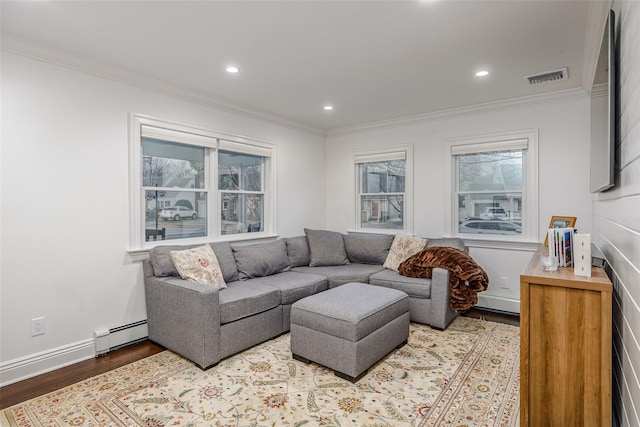 living room with a baseboard radiator, crown molding, visible vents, and wood finished floors