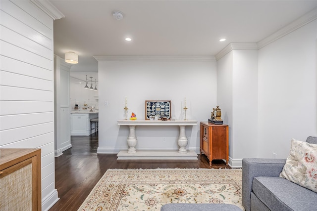 sitting room with baseboards, recessed lighting, dark wood finished floors, and crown molding