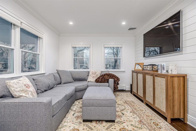 living area with ornamental molding, a baseboard radiator, visible vents, and wood finished floors