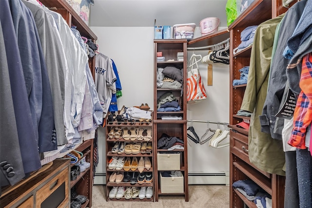 walk in closet featuring a baseboard heating unit and carpet flooring