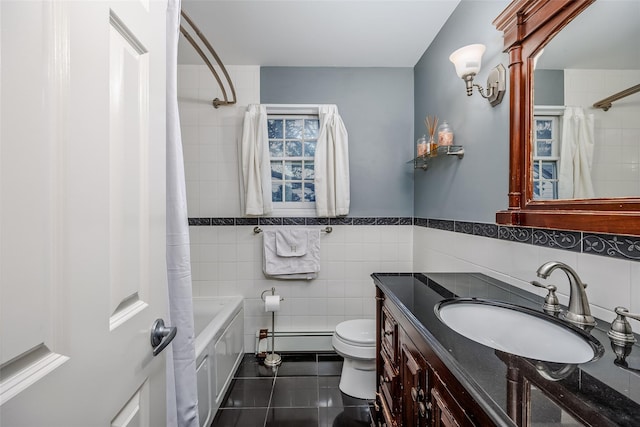 bathroom featuring tile walls, toilet, a baseboard heating unit, vanity, and tile patterned floors