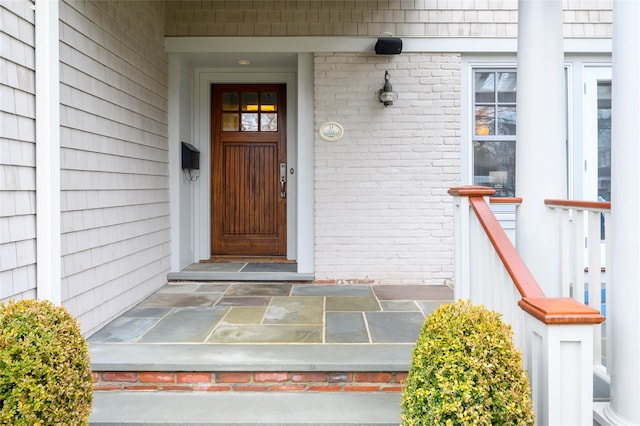 entrance to property featuring brick siding